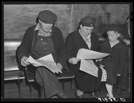 Farm couple reading over ballots. Election day, November 1940. McIntosh County, North Dakota