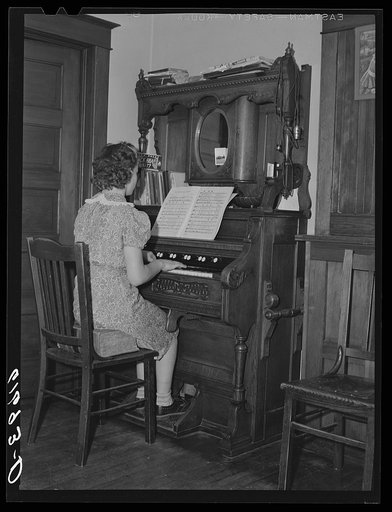 Farm girl playing organ. McIntosh County, North Dakota