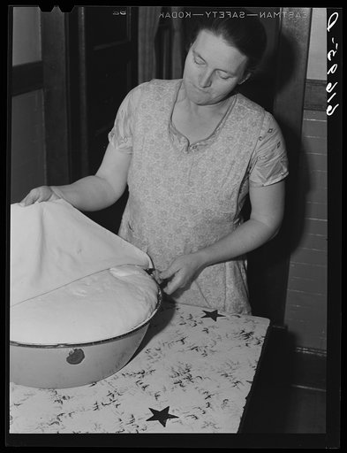Mrs. Bettenhausen with bread she is baking. McIntosh County, North Dakota