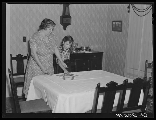 Mrs. Schulstad and daughter laying the table for dinner. Aberdeen, South Dakota
