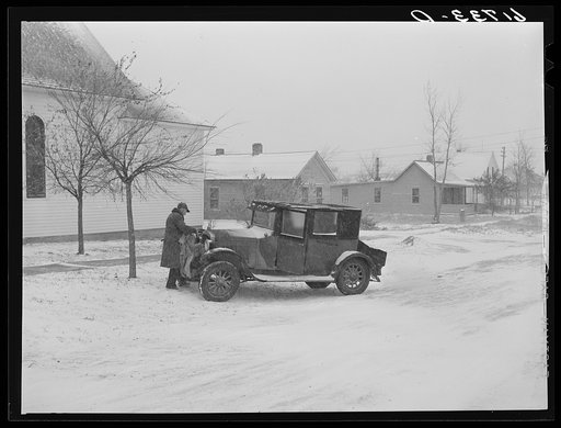 Putting blanket over auto radiator. Miller, South Dakota