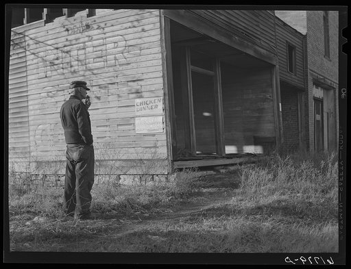 Old storekeeper and abandoned store in near ghost town. Shaw, Kansas