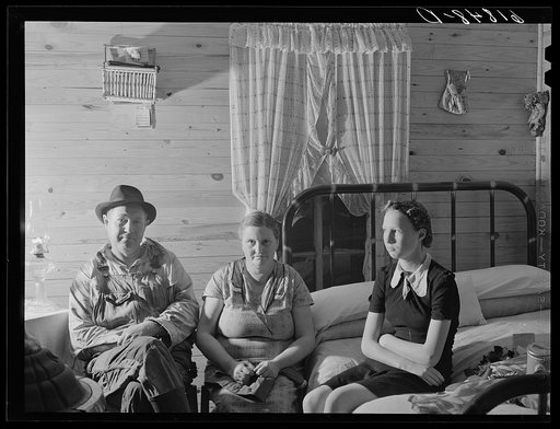 Agricultural day laborer, wife and daughter in new home built by FSA (Farm Security Administration). New Madrid County, Missouri