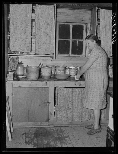 Wife of agricultural day laborer in kitchen of one of the new scattered labor homes built by FSA (Farm Security Administration). New Madrid County, Missouri