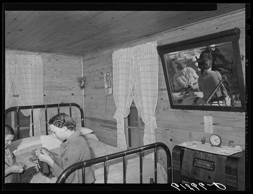 Combination living and bedroom in one of the four-room scattered labor homes built by FSA (Farm Security Administration) at a cost of five hundred dollars. New Madrid County, Missouri
