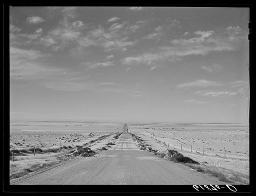 U.S. Highway no. 18 through Shannon County, South Dakota. Tumbleweeds lining edges of road
