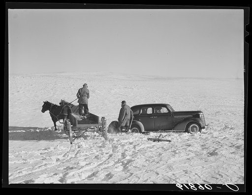 Pulling government car out of snow drift. Todd County, South Dakota