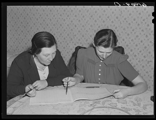 Home supervisor helping rehabilitation borrower with FSA (Farm Security Administration) account book. Labette County, Kansas