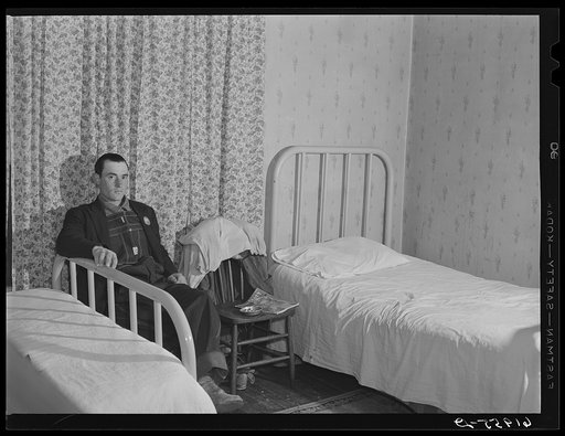Powder plant's construction worker in his bedroom at Mrs. Pritchard's boardinghouse. Radford, Virginia