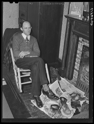 Carpenter at Hercules powder plant in his room in Sunday clothes, workclothes on the floor in front of him. He came here a month ago from Long Branch, West Virginia. Pays eight dollars a week room and board. Left his family at home. Would send for them if he could find a decent place to live. Radfor