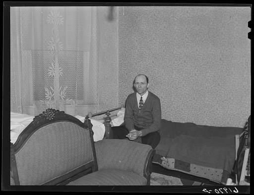 Carpenter on his bed in room which he shares with another Hercules worker. Radford, Virginia