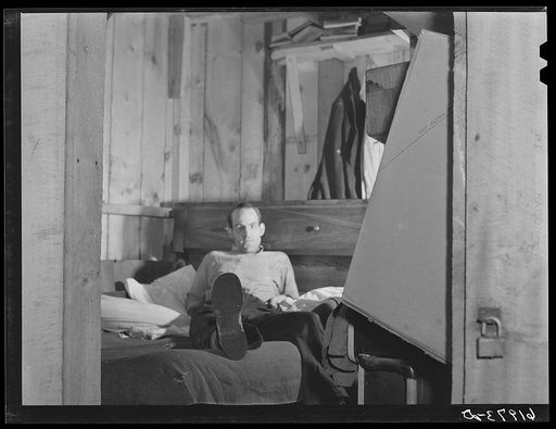 Untitled photo, possibly related to: W.W. McDaniel, rigger at Hercules powder plant, in his bunkhouse in the rear of Mrs. Pritchard's boardinghouse. Radford, Virginia