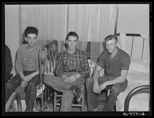 Men in room at Mrs. Jones's boardinghouse. Six men live in this room. Three beds, pay eight to ten dollars a week rent. Most of them have families they left behind in Bluefield, West Virginia; Bristol, Tennessee; or High Point, North Carolina. They are carpenters, carpenters' assistants, riggers and