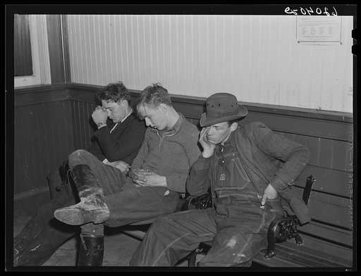 Men sleeping in railroad station, Radford, Virginia. They come in from out of town to work in the powder plant and are often unable to find a place to stay the first night