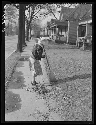 Woman sweeping leaves. Birmingham, Alabama