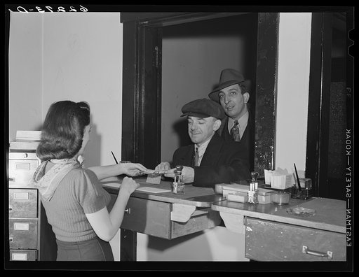 Untitled photo, possibly related to: Steelworker paying dues at steelworkers organizing committee office. Ambridge, Pennsylvania