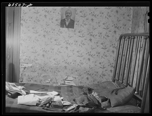 Bedroom in house in Negro slum district. Norfolk, Virginia