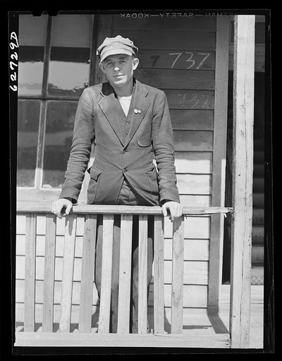 Navy yard worker on porch of rooming house. Portsmouth, Virginia