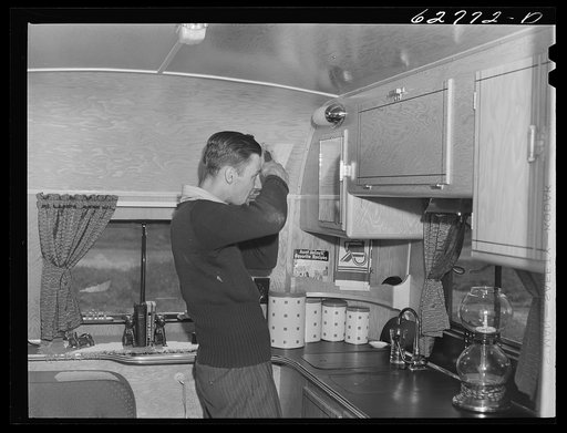Employee at General Electric plant getting ready to work. Trailer camp at Erie, Pennsylvania
