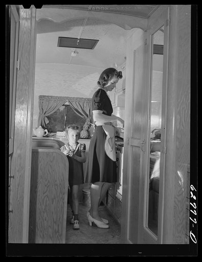 Untitled photo, possibly related to: Mr. and Mrs. Jack Cutter preparing noonday meal in kitchen of their trailer home. FSA (Farm Security Administration) camp, Erie, Pennsylvania
