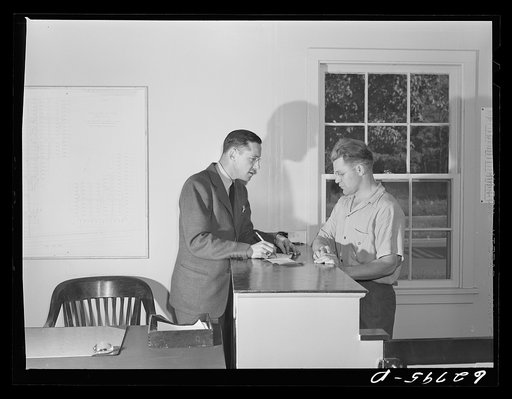 General Electric employee applying for trailer at FSA (Farm Security Administration) camp office. Milton Ackerman, camp manager, is interviewing him. Erie, Pennsylvania