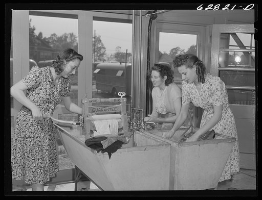 Women washing clothes in utility building at FSA (Farm Security Administration) trailer camp. Erie, Pennsylvania