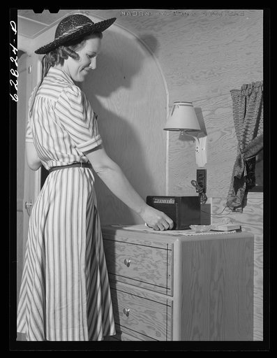 Tuning in radio in trailer at FSA (Farm Security Administration) camp. Erie, Pennsylvania