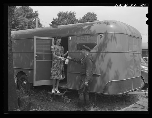 Milk delivery at trailer in FSA (Farm Security Administration) camp for defense workers. Erie, Pennsylvania