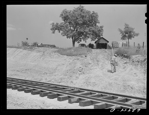 Railroad track running through former pasture land in Martin County, Indiana. A naval ammunition depot comprising 42,000 acres is being constructed here. 160 farm families are to be affected