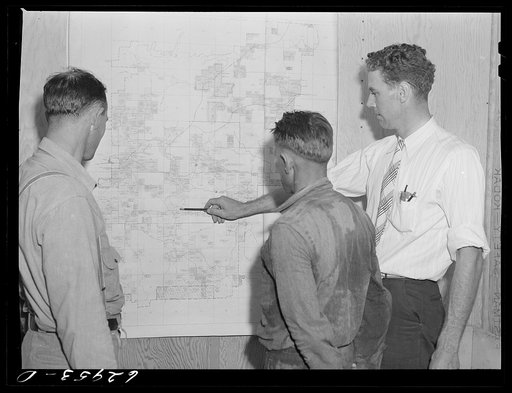 Paul Sharpe, supervisor of FSA (Farm Security Administration) relocation project at Burns City, Indiana, talking with two of the farmers who will be moved during construction of naval ammunition depot