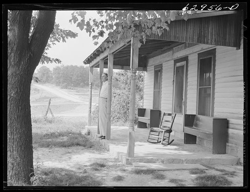 Luther Corbin on front porch of farm house in Martin County, Indiana. Construction of naval ammunition depot has begun on his property, but he will continue to occupy house until it is necessary to tear it down