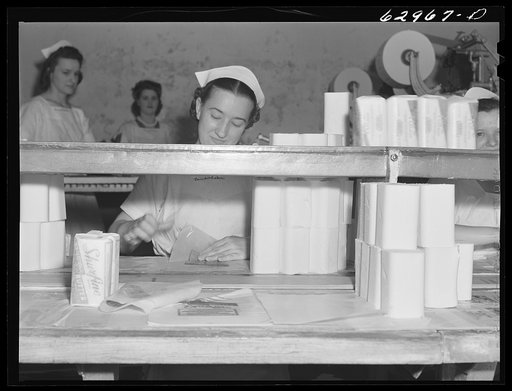 Untitled photo, possibly related to: Butter going through machine which cuts it into quarter-pound sections. Land O'Lakes plant, Chicago, Illinois