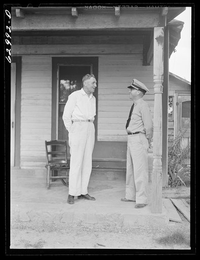 Lieutenant Sedgewick of United States Navy talking with Luther Corbin, a farmer whose land has been bought by Navy for construction of ammunition depot. Martin County, Indiana