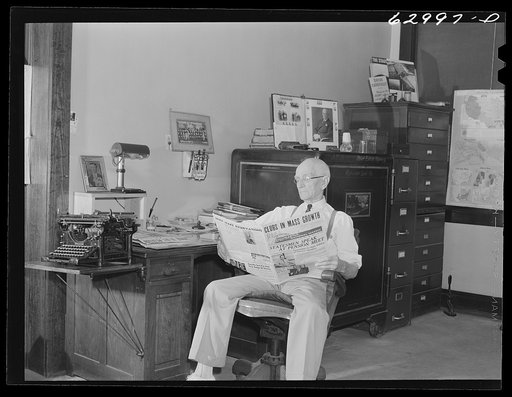 John W. Dillard, real estate and insurance man, and member of local Townsend Club, in his office at Washington, Indiana
