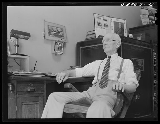 Untitled photo, possibly related to: John W. Dillard, real estate and insurance man, and member of local Townsend Club, in his office at Washington, Indiana