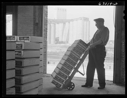 Warehouse at fruit terminal, Chicago, Illinois. Shipments of fruit by commission merchants at auction are loaded onto trucks as soon as drivers and loaders can be notified what shipments have been bought