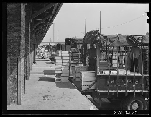 Loading crates of fruits into truck at fruit terminal. Chicago, Illinois