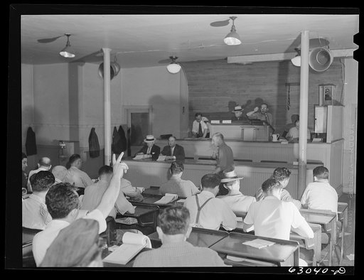 Commission merchants bidding in auction at fruit terminal. Chicago, Illinois