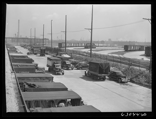 Trucks of commission merchants lined up outside fruit terminal to haul produce market what has been bought at auction. Chicago, Illinois