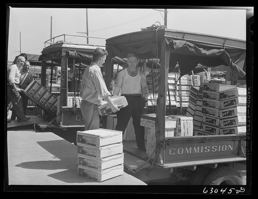Untitled photo, possibly related to: Loading crates of fruits into truck at fruit terminal. Chicago, Illinois