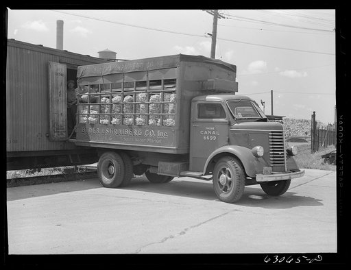 Loading potatoes onto truck from freight car. Chicago, Illinois