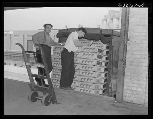 Crates of fruits loaded onto truck at fruit terminal. Chicago, Illinois