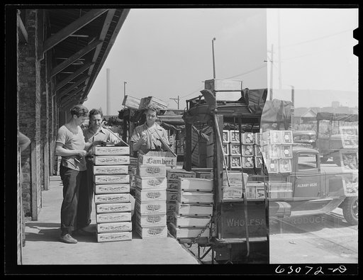 Untitled photo, possibly related to: Loading crates of fruits into truck at fruit terminal. Chicago, Illinois