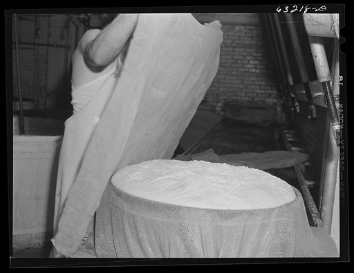 Untitled photo, possibly related to: Placing cheese cloth over the curd. Swiss cheese factory. Madison, Wisconsin