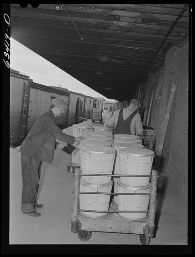 Untitled photo, possibly related to: Loading tubs of butter onto freight car. Land O'Lakes plant. Minneapolis, Minnesota