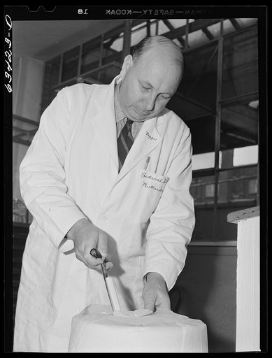 Federal inspector taking sample of tub butter. Land O'Lakes plant, Minneapolis, Minnesota