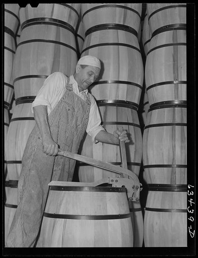 Clamping top on barrel of powdered milk. Milk condensary, Antigo, Wisconsin