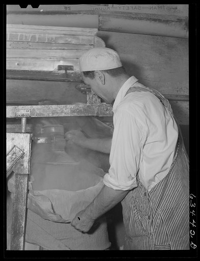 Filling barrel with powdered milk at condensary. Antigo, Wisconsin