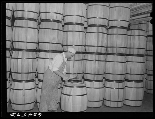 Clamping top on barrel of powdered milk. Condensary at Antigo, Wisconsin