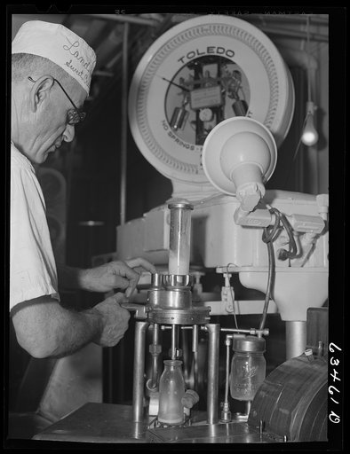 Taking a sample from can of milk to determine butterfat content. Antigo, Wisconsin